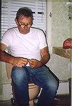 Here's Captain Norm Bartlett at his improvised tying bench during a smallmouth trip to Connecticut in August of 1986. No vise required.