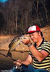 Marylander Bob Blatchley shows a smallmouth bass caught on Fontana Lake in North Carolina. Circa 1975.