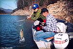 Phyliss Goodspeed nets a smallmouth bass for husband Tom on North Carolina's Fontana Cake. Circa 1975.