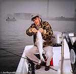 Joe Reynolds and a nice fly-caught striped bass near the Route 50 Bridge in Ocean City, Maryland. 2005.