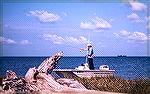 Casting along the marsh banks near Crisfield, Maryland for striped bass in th mid 70s. Photo by Chuck Edghill.